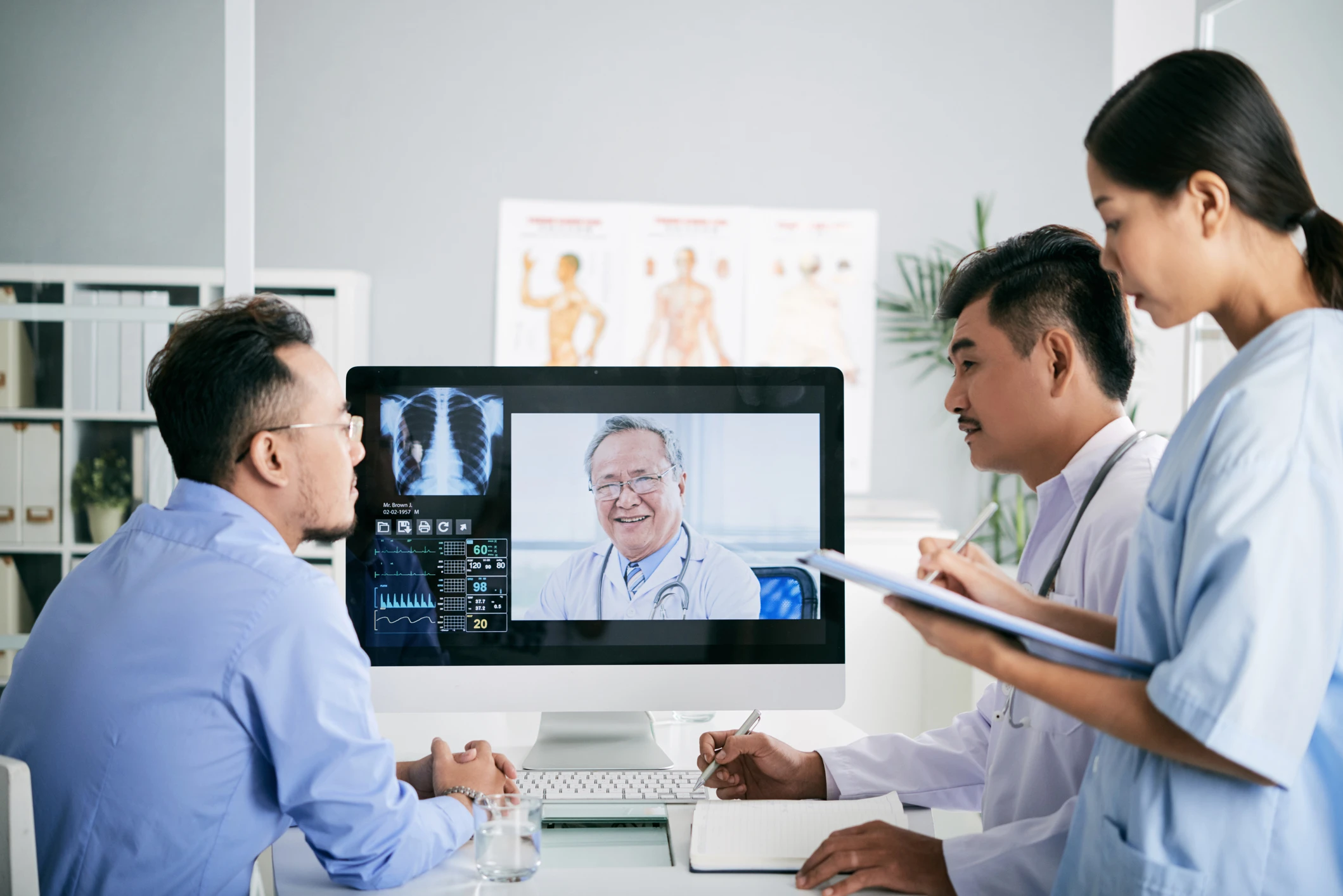 Doctors looking at app on screen